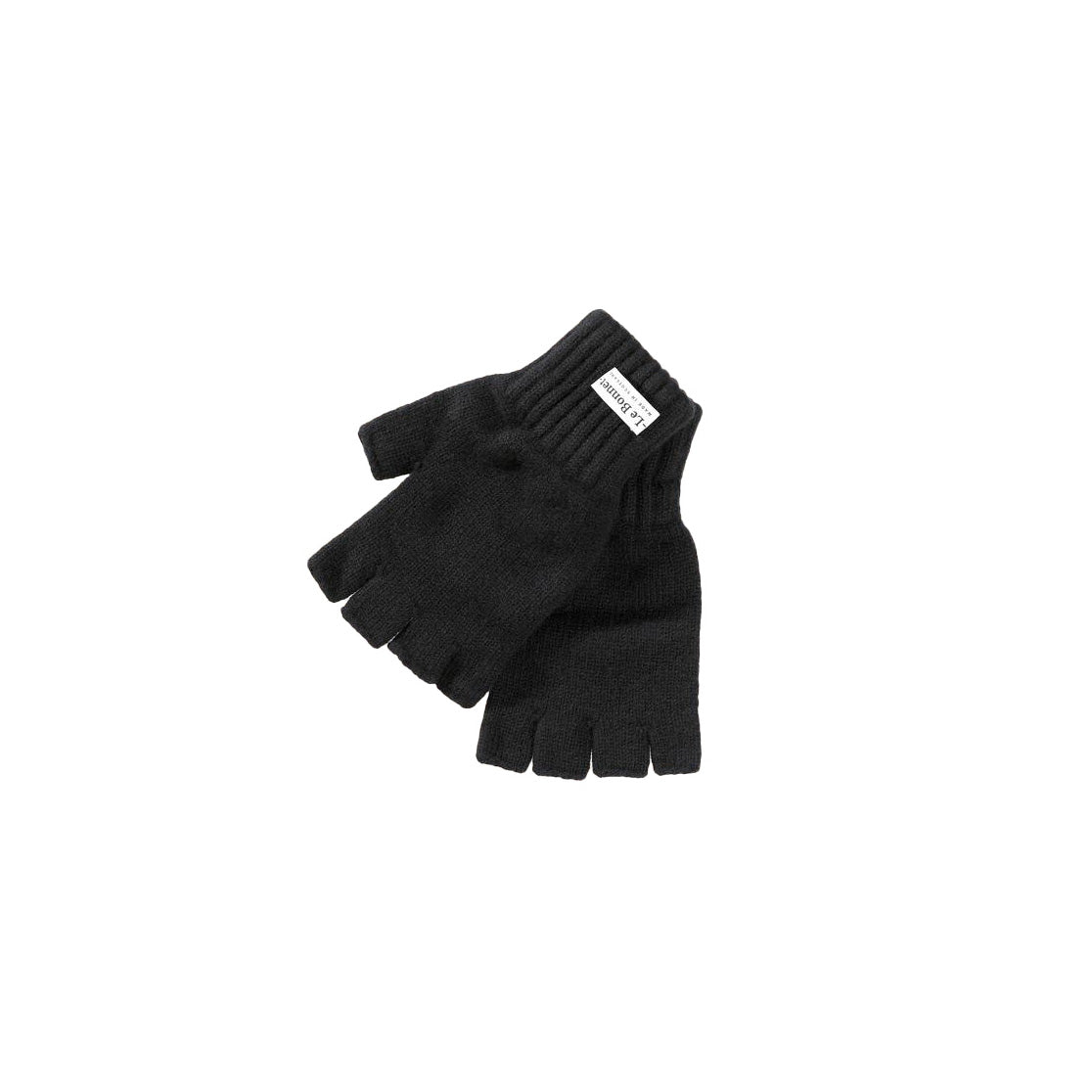 A pair of black Merino wool fingerless gloves by Le Bonnet features a white label on the wrist. Crafted in Scotland, these stylish accessories blend comfort and elegance effortlessly.