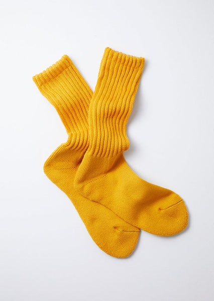 A pair of RoToTo Loose Pile Crew Socks in yellow is laid flat against a white background.