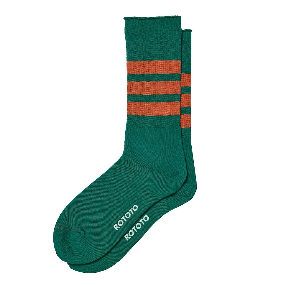 A pair of Fine Pile Striped Crew Socks in green and dark orange, featuring three horizontal dark orange stripes near the top and the brand name "RoToTo" printed in white on the foot.