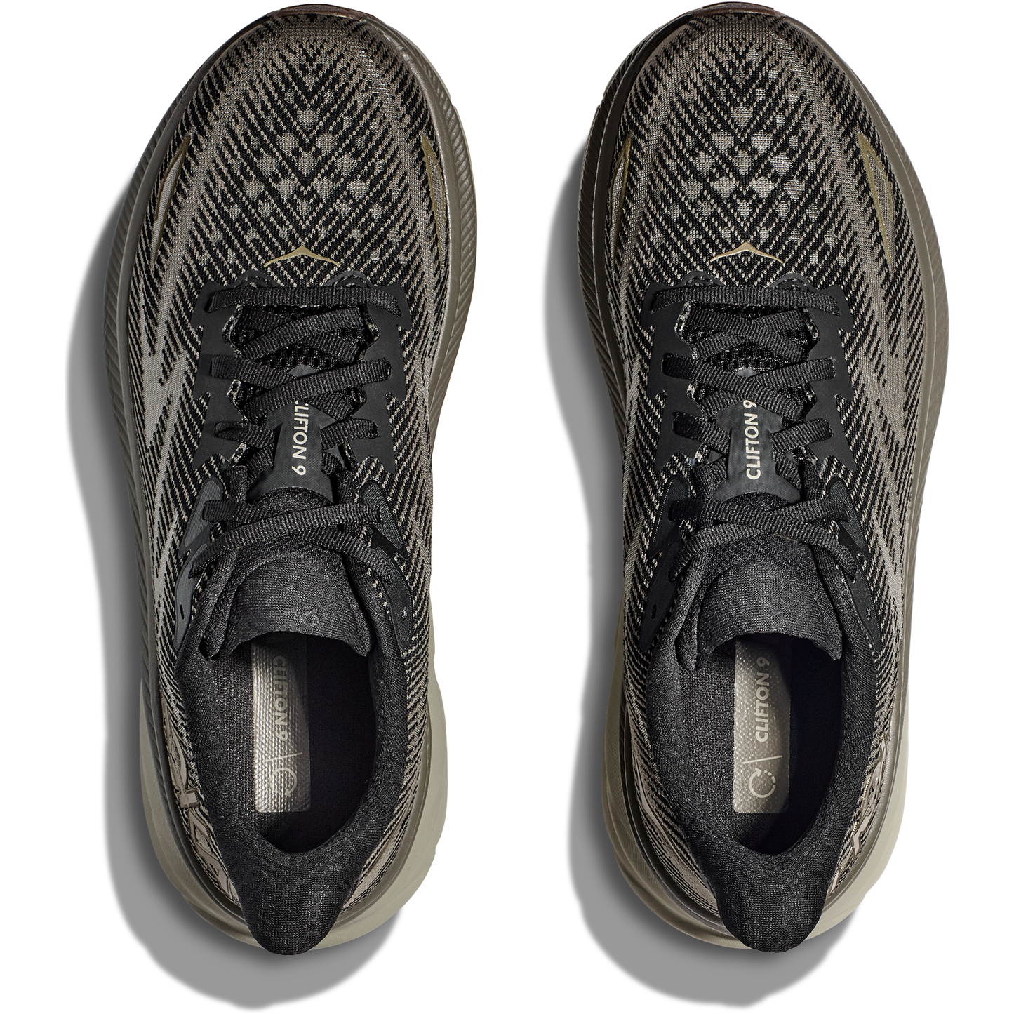 Top view of a pair of M Clifton 9, Black/Slate athletic shoes by Hoka with patterned uppers and laces, featuring a protective cushion for added comfort.