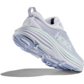 A light purple athletic shoe with a thick, cushioned sole and the brand name "Hoka" visible on the side. The shoe, identified as W Bondi 8, Ether/Illusion from Hoka, is shown from the bottom, highlighting its tread pattern. Experience an enhanced soft ride with its softer, lighter foams.
