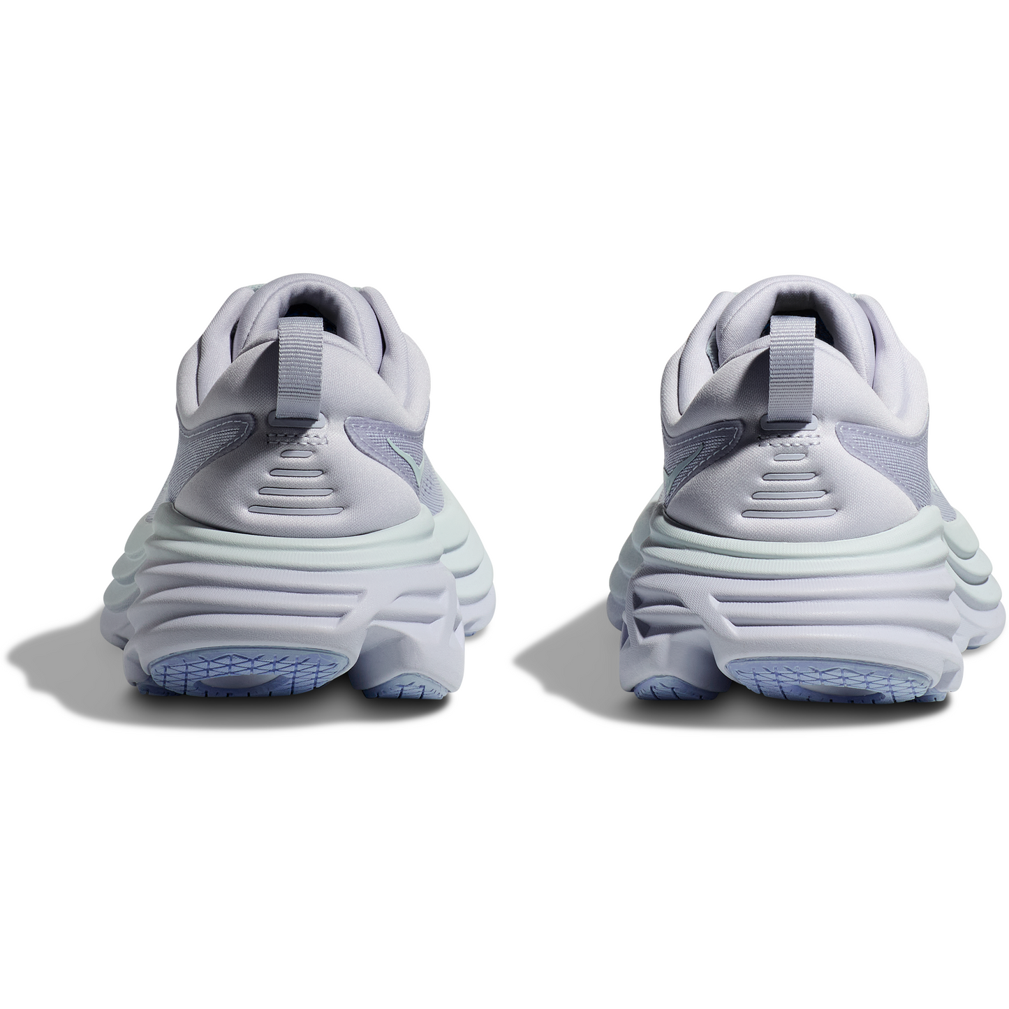 Rear view of a pair of light purple athletic sneakers with thick, textured soles, featuring enhanced soft ride technology — the W Bondi 8, Ether/Illusion by Hoka.