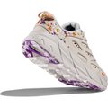 A single beige sneaker with floral embroidery and a chunky sole featuring purple accents, viewed from the heel and sole angle, offering a lightweight ride reminiscent of the Hoka W Clifton L BP, Nimbus Cloud/Nimbus Cloud.