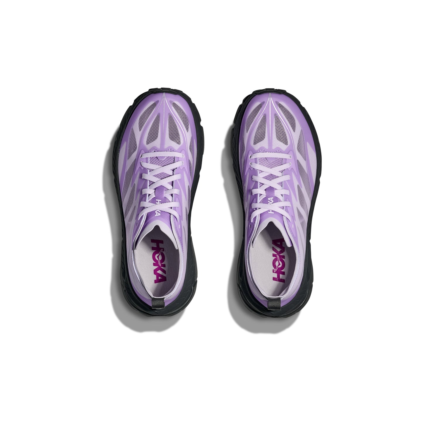 The Hoka U Mafate Speed 4 Lite running shoes, in purple and white with black soles, feature a breathable mesh upper and are displayed from above on a white background.