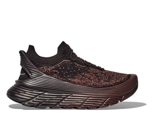 A side view of the Hoka U Restore Chukka Paria Farzaneh, a black unisex sneaker featuring a sleek design with intricate weaving and a thick, textured sole.