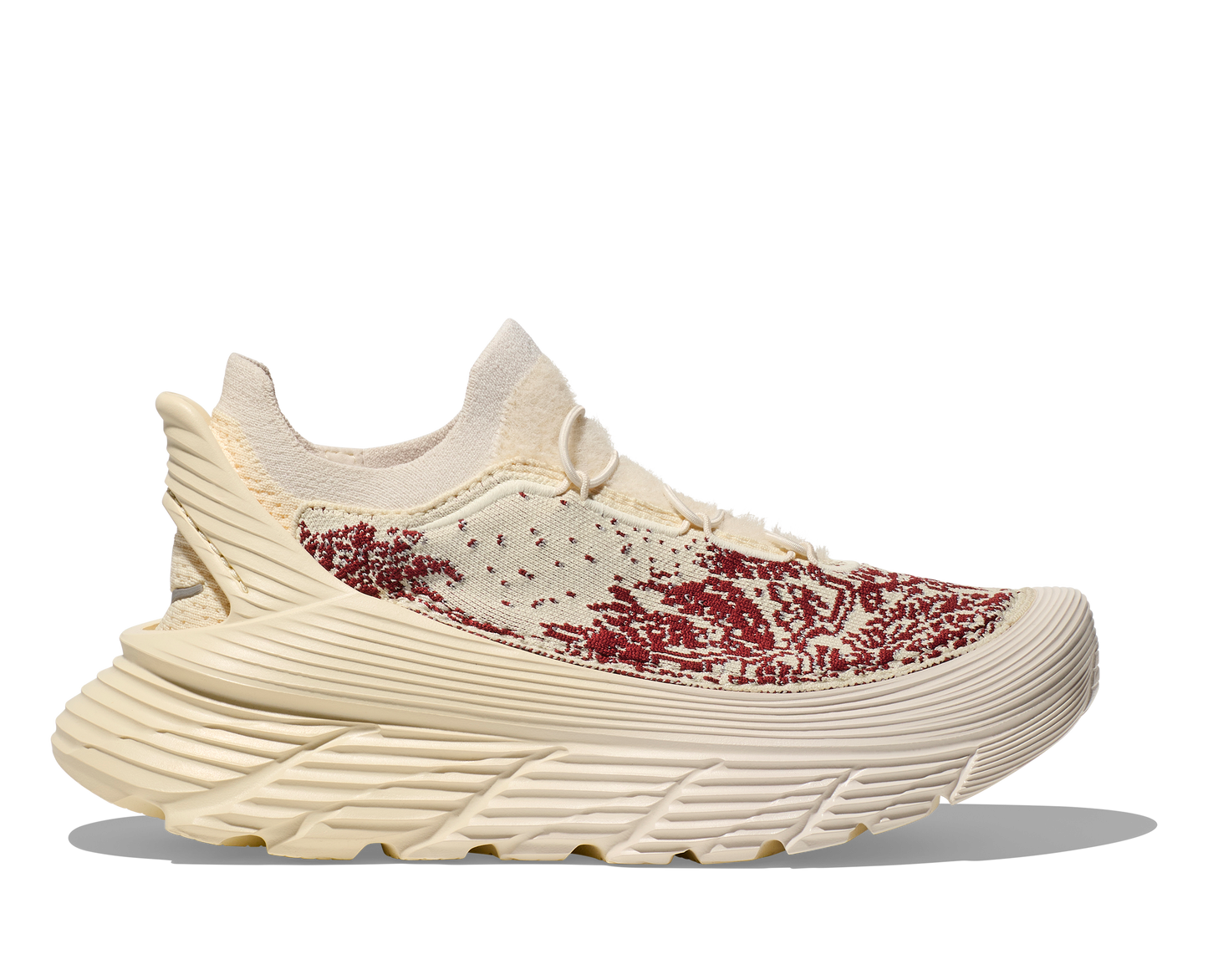 Introducing the Hoka U Restore Chukka Paria Farzaneh, a unisex sneaker in beige and maroon, featuring a textured sole and an upper material with a knit pattern.