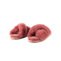 The Lovisa Slipper in Marsala, from Shepherd of Sweden, is a pair of pink, fluffy slippers with open toes and a slip-on design, isolated on a white background.