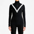 A model in a W Voss Chevron Zip-Up by We Norwegians, featuring a black turtleneck with white chevron pattern from soft Merino wool, paired with sleek black pants. Styled in women's sizing against a pristine white background.