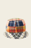 A vibrant and stylish reversible bucket hat by Original Madras Trading Co., showcasing a patchwork design with various plaid and checkered sections on a beige background, known as the Blue Multi.