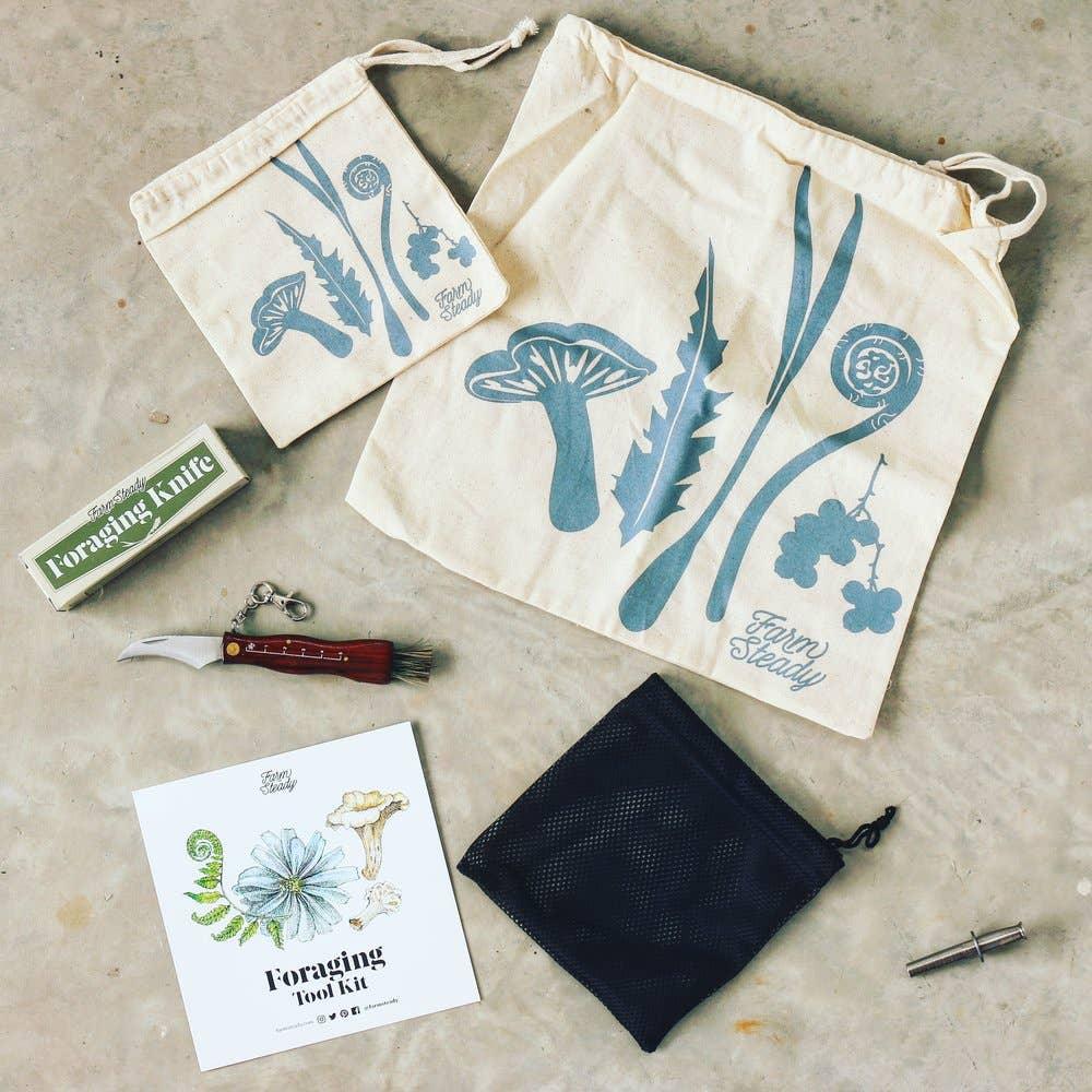 A FarmSteady Foraging Tool Kit includes two drawstring bags, a pocket knife, a mesh bag, a tool replacement part, and a booklet titled "Foraging Toolkit.