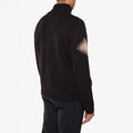 The person is wearing a dark M Hovden Sweater by We Norwegians, featuring a geometric pattern on the sleeve, seen from the back.