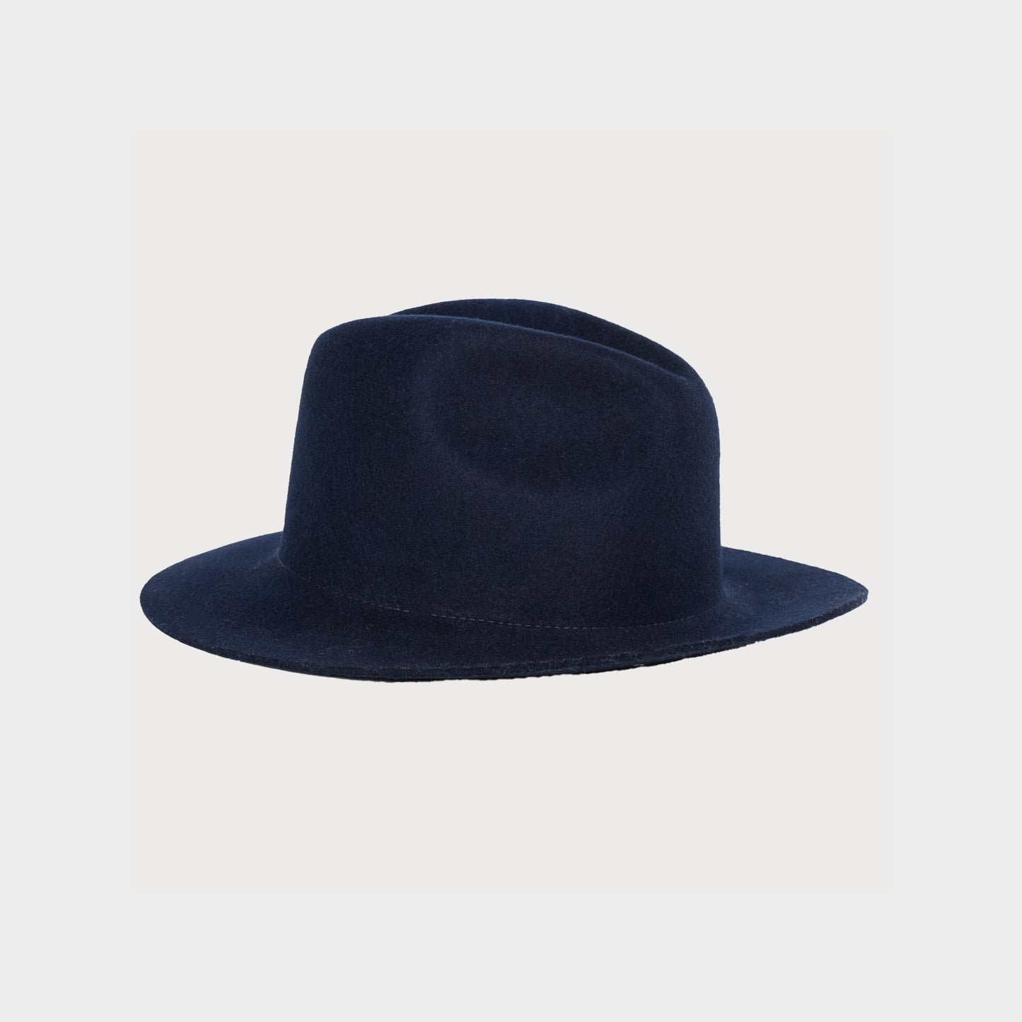 The Snap Brim Fedora, Navy by F & M Hat Company features a wide brim and indented crown against a plain background.