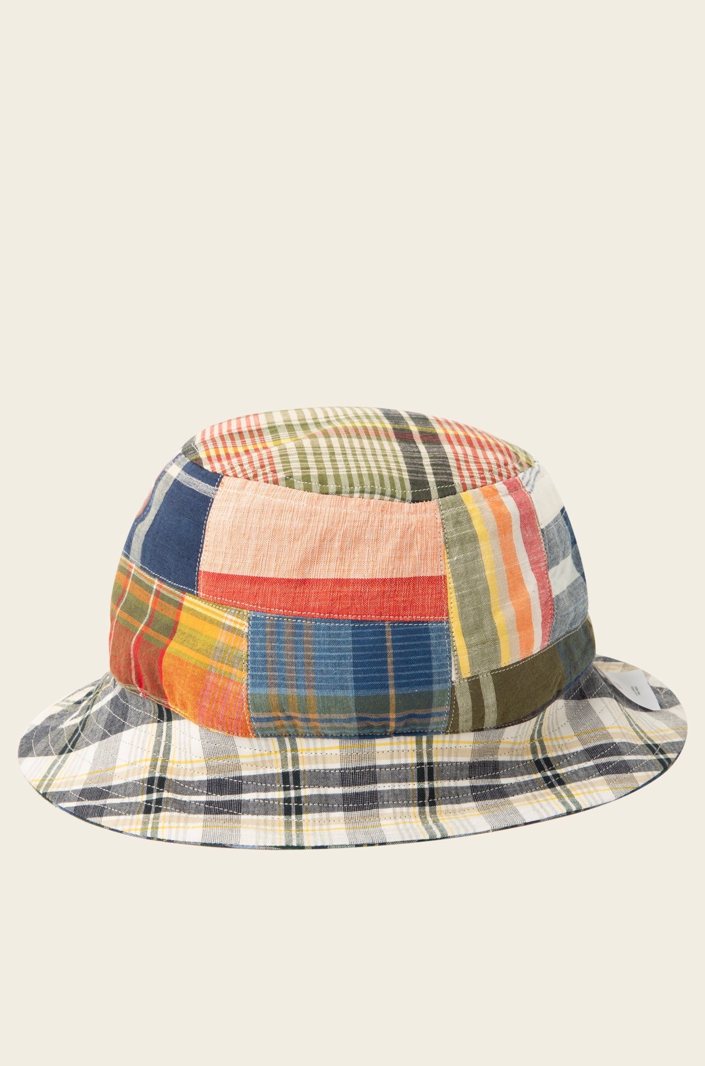 Reversible Bucket Hat from Original Madras Trading Co. in Blue Multi, showcasing a vibrant patchwork design with an assortment of plaid and checkered patterns set against a plain background.