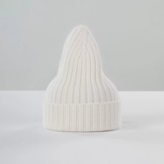 Le Bonnet's Large Beanie in Snow, featuring a ribbed knit and pointed top, is displayed against a light grey background.