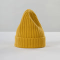 The Large Beanie in mustard by Le Bonnet is displayed upright on a neutral background, showcasing its chunky knit design with a folded brim for maximum comfort.