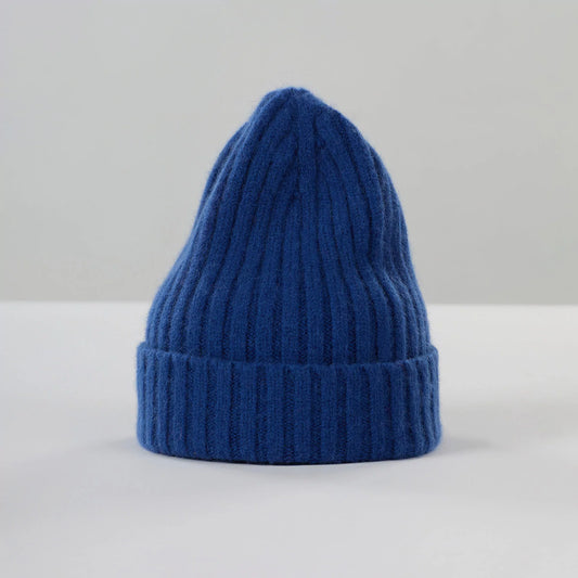 The Le Bonnet "Large Beanie, Marin" is a chunkier lambswool beanie with a folded brim, standing upright on a white surface against a light gray background.