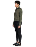 A person in the Ada Women's Quilted Full Zip Sweater by Nobis, black pants, and sneakers stands facing left against a plain background.