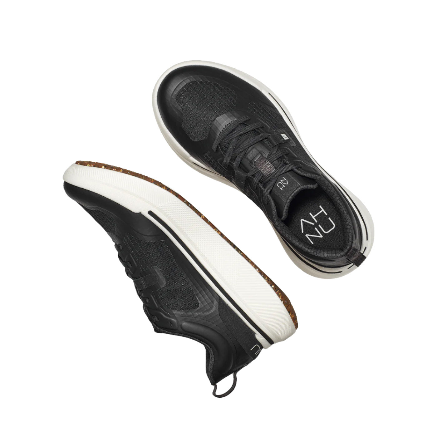 Two AHNU W Sequence Low black sneakers, featuring innovative rocker geometry with white soles and brown outsoles, are shown in a sleek floating arrangement against a pristine white backdrop.