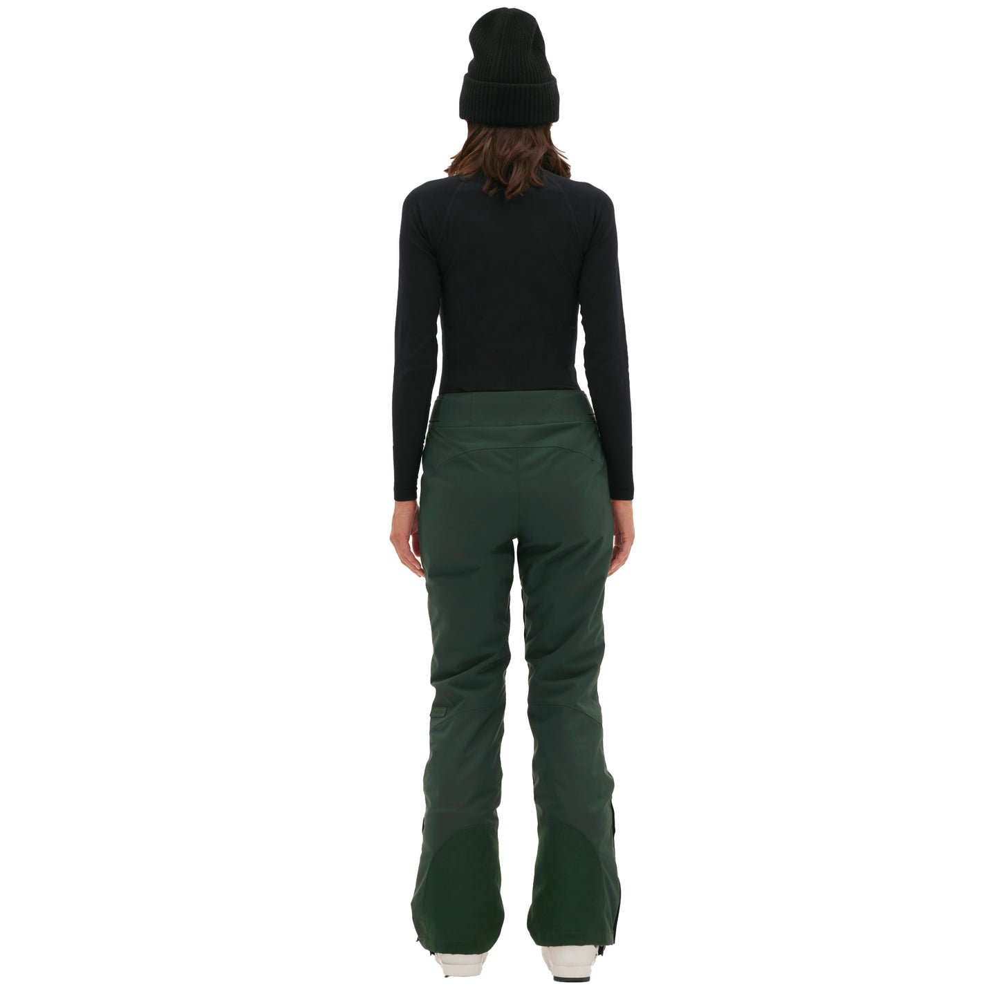 Someone in a black long-sleeve top and Halfdays' classic green Alessandra Pant, matched with a black beanie, stands facing away.