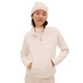 A person is wearing a classic beige Bonnie Fleece Top by Halfdays and a matching beanie, with hands in the front pockets, standing against a white background.