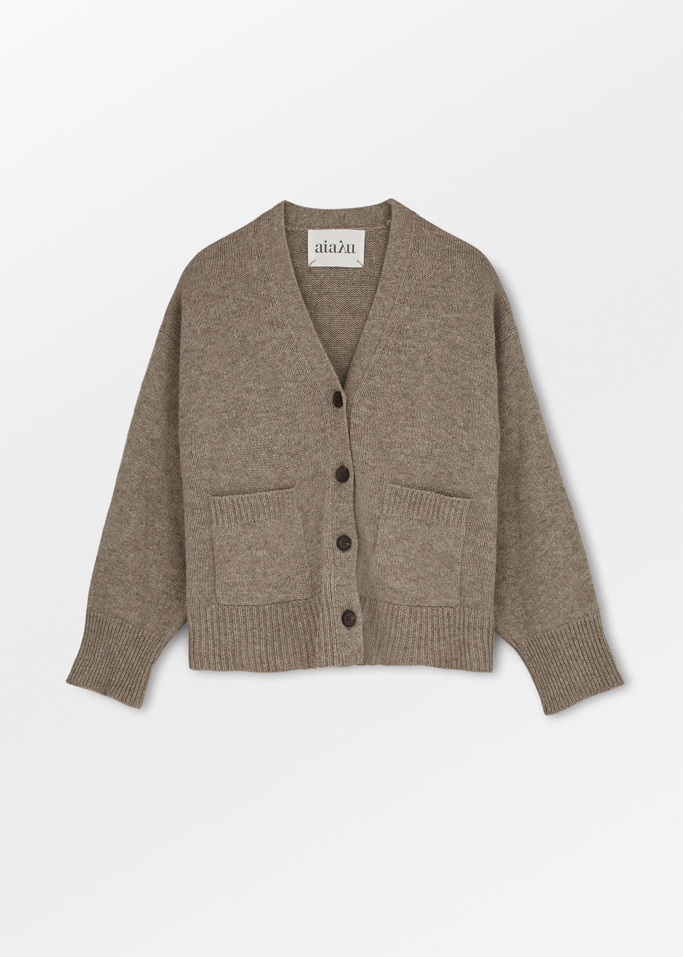 The Cora Cardigan by Aiayu is a beige, long-sleeve buttoned cardigan featuring handmade horn buttons, ribbed cuffs and hem, front pockets, and a v-neck.