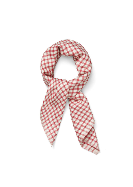 A Familia Scarf by Aiayu, featuring a hand-loomed red and white checkered design, tied in a loose knot.