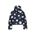 The Grand Ski Jacket, Dot Black by Goldbergh is a navy blue puffer jacket with a white polka dot pattern, equipped with a hood and visible stitching.