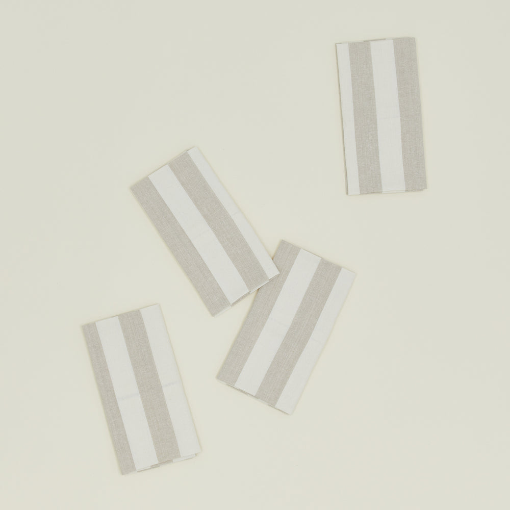 The Essential Striped Dinner Napkins (Set of 4) by Hawkins New York, part of the timeless home basics collection, are arranged on a light background.