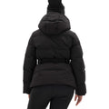 A person is seen from the back, clad in a black Hedy Puffer Jacket by Halfdays and black pants, ready to showcase mountain performance features on the slopes.