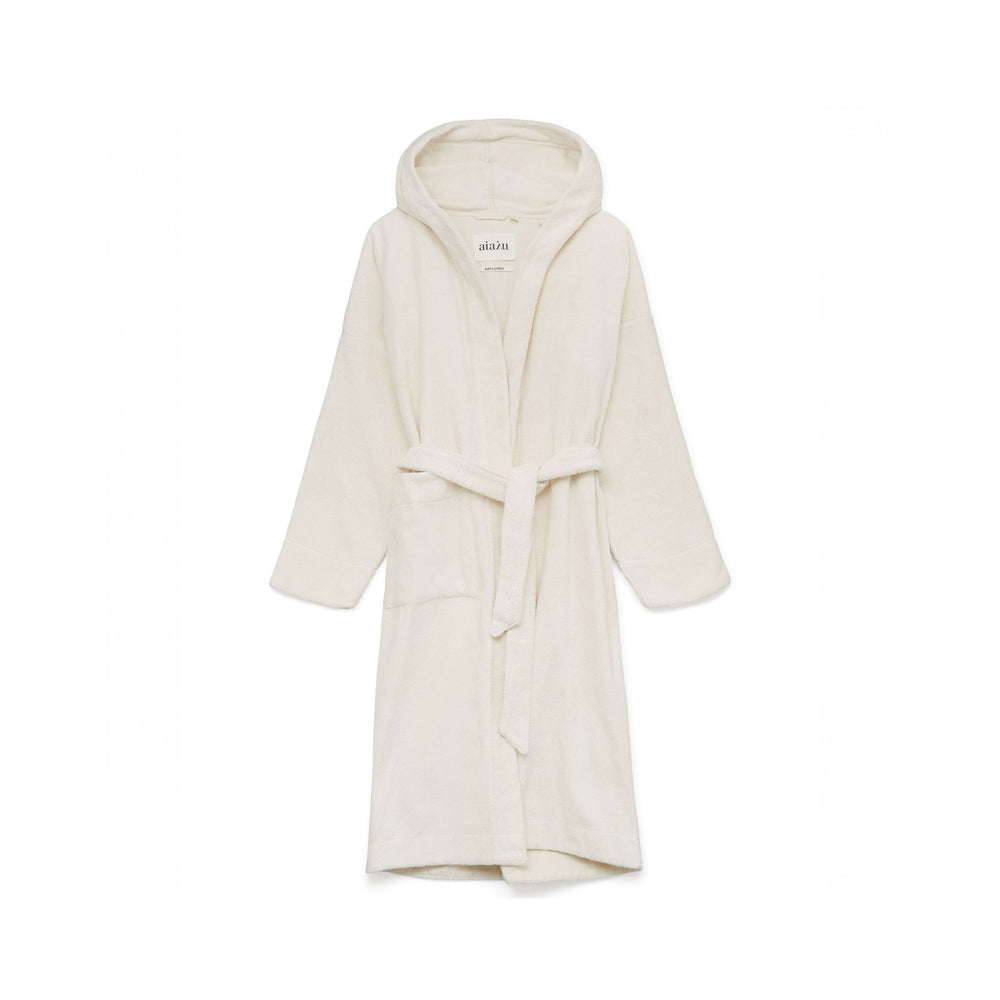 A Hooded Terry Bathrobe by Aiayu, made from Organic Chetna Cotton, hangs against a plain backdrop, highlighting its sustainable and high-quality craftsmanship from India.