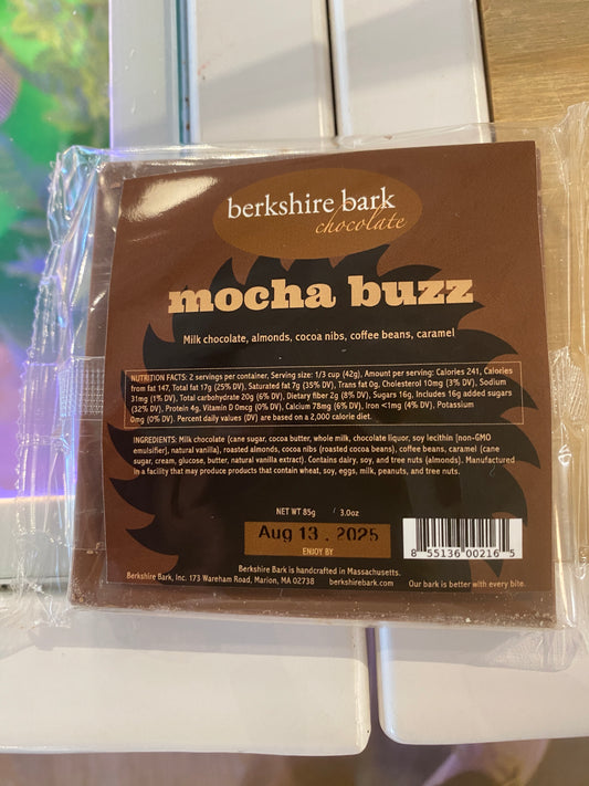 A packaged Westerlind Berkshire Bark Chocolate - Mocha Buzz bar includes milk chocolate, almonds, cocoa nibs, coffee beans, and caramel. Best by: August 13, 2025.