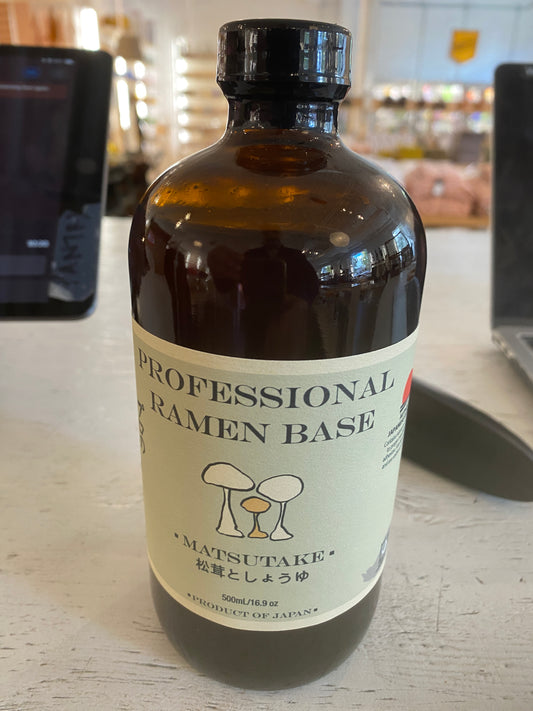 A brown bottle labeled "Westerlind Professional Ramen Base - Matsutake" sits on a light-colored table.