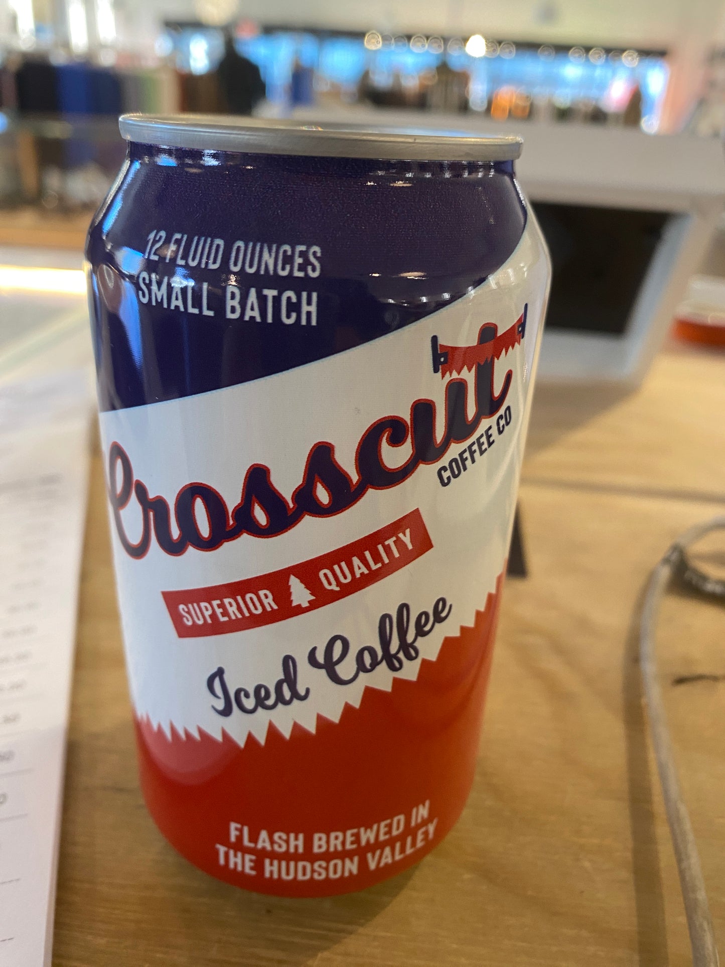 A can of Westerlind's Crosscut Iced Coffee on a table, labeled with "Superior Quality" and "Flash Brewed in the Hudson Valley.