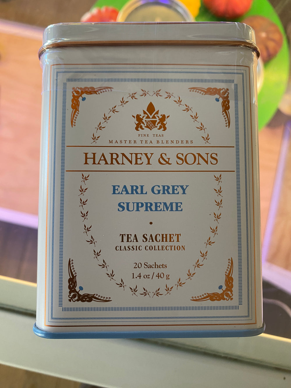 A tin of Westerlind Earl Grey Supreme Tea sits with a classic design on a glass surface.