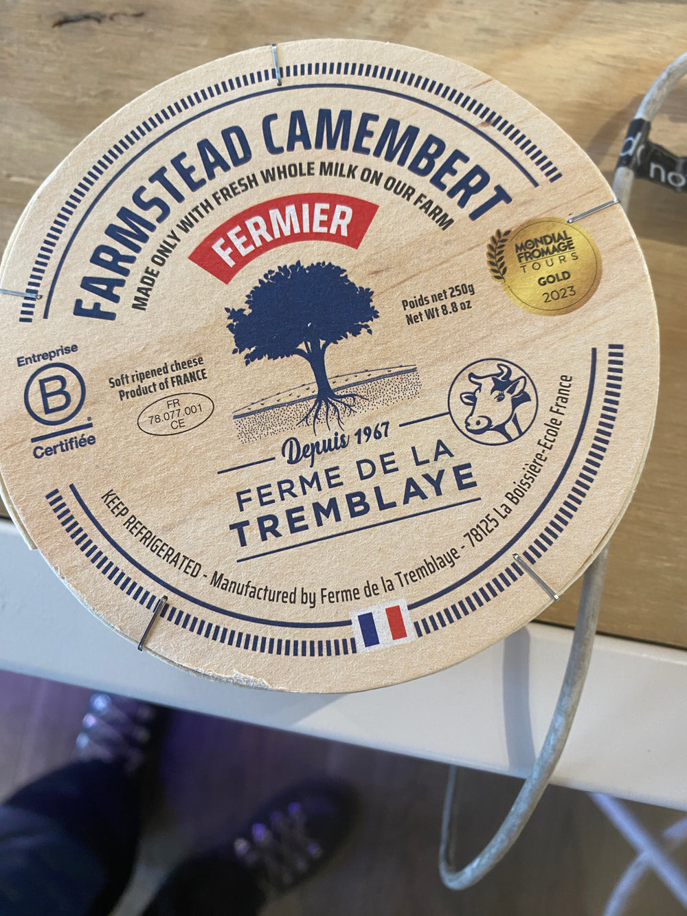 The lid of a Camembert Ferme de la Tremblaye cheese by Westerlind highlights awards, weight, certification, and its French origin since 1967.