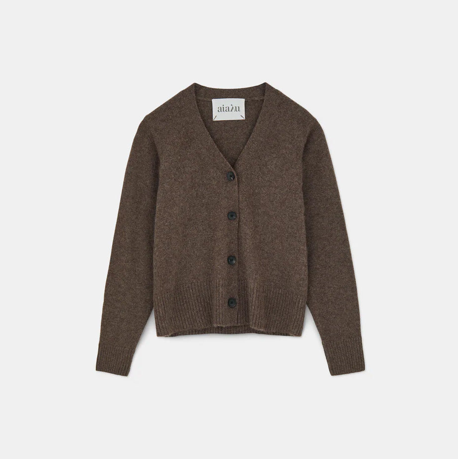 The Ingrid Cashmere Cardigan by Aiayu, a feminine-fit brown sweater with long sleeves and V-neck, elegantly displayed on a plain background. It features chic horn buttons that enhance its sophistication.