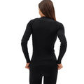 A person, dressed in a fitted Johnson top by Halfdays and matching pants, exudes an active outdoor fit as they're viewed from behind. The sleek nylon seamless base layer perfectly complements their streamlined silhouette.