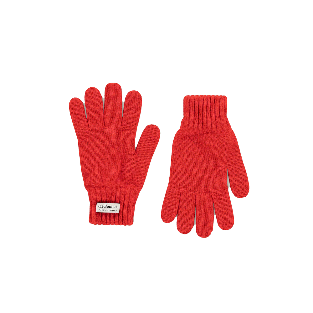 Ideal for chilly weather, this pair of Le Bonnet red knit gloves with ribbed cuffs is made from luxurious Merino wool. With a small label on one glove, they add a cozy Scottish charm to your wardrobe.