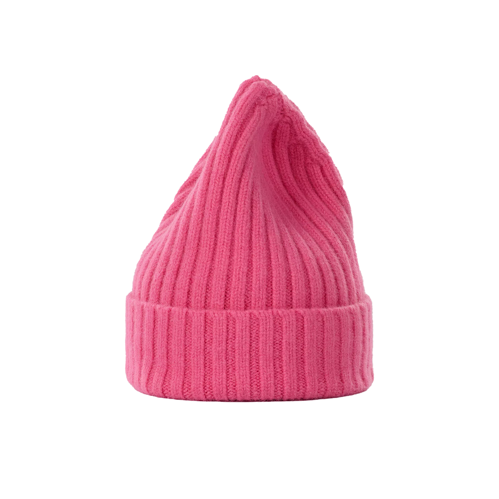 A large, bright pink ribbed knit beanie hat from Le Bonnet, made from luxurious lambswool with a chunkier texture and a pointed top, set against a plain background.