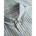 Close-up of a blue and white striped Kristian Linen B.D. Shirt, Washed Denim Blue/Ivory with a button-down collar, featuring a visible label reading "Les Deux.