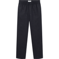 Patrick Linen Pants in Dark Navy by Les Deux, made from breathable material, with a drawstring waist, displayed on a neutral background.