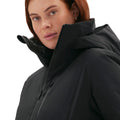 A red-haired woman wears a black Lawrence Jacket by Halfdays, featuring a high collar as she gazes forward against a plain backdrop.