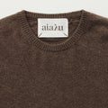 Close-up of a brown Leonardo Cashmere Sweater with a white label inside the collar, showcasing the brand name "Aiayu," ideal for a genderless wardrobe.