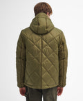 The image shows the back view of a person wearing a Barbour Re-Engineered Endurance Quilted Jacket with diamond quilting. They are also wearing green pants.