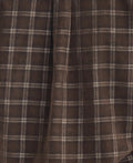 Close-up of a brown, plaid fabric with a soft texture, featuring intersecting lines forming a country check pattern reminiscent of the Barbour Harthill Tailored Long Sleeved Cord Shirt.