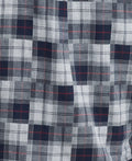 Close-up image of a fabric from the smart-casual collection, featuring a plaid pattern with shades of blue, white, and black, and thin red lines interspersed. This detailed design echoes the sophisticated feel of the Barbour Sault Tailored Long-Sleeved Shirt.