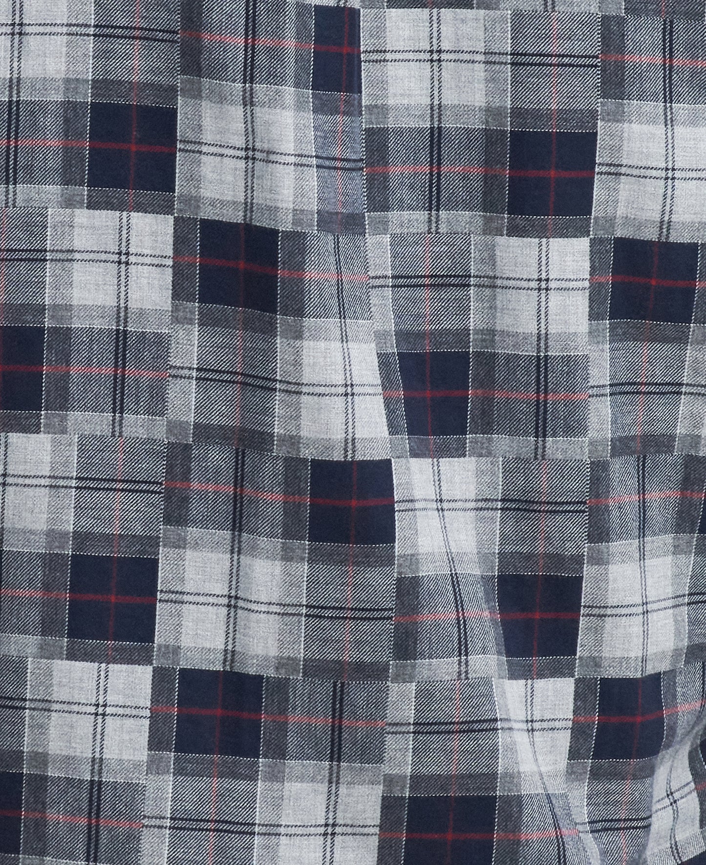 Close-up image of a fabric from the smart-casual collection, featuring a plaid pattern with shades of blue, white, and black, and thin red lines interspersed. This detailed design echoes the sophisticated feel of the Barbour Sault Tailored Long-Sleeved Shirt.