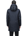 Back view of a person wearing the Yves Men's Parka by Nobis, a stylish dark winter coat with a buckle detail on the hood, perfect for harsh winter conditions.