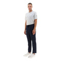 A person stands facing forward, wearing a white t-shirt, Herno M Laminar Nylon Pants in Navy with an adjustable drawstring, and white sneakers on a plain white background.