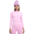 A person is wearing the ultra-flattering pink Johnson top by Halfdays, paired with matching pink pants and a lavender beanie, standing facing forward against a plain white background.